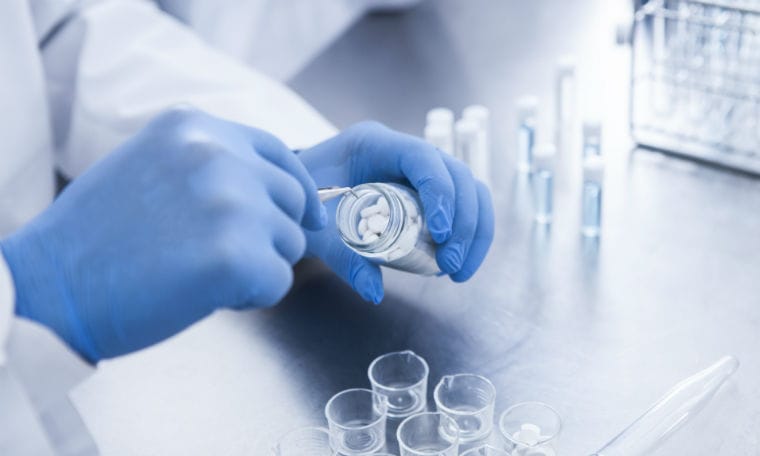 a Pharmacist puts pills in containers.